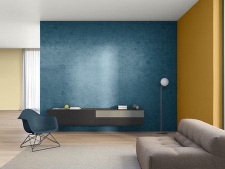 Ein modernes Wohnzimmer mit einer blauen Wand, einem dunkelbraunen Sideboard mit einer grauen Schublade Links steht ein blauer Stuhl und rechts ein Stehlampe mit einem runden Lampenschirm. 
